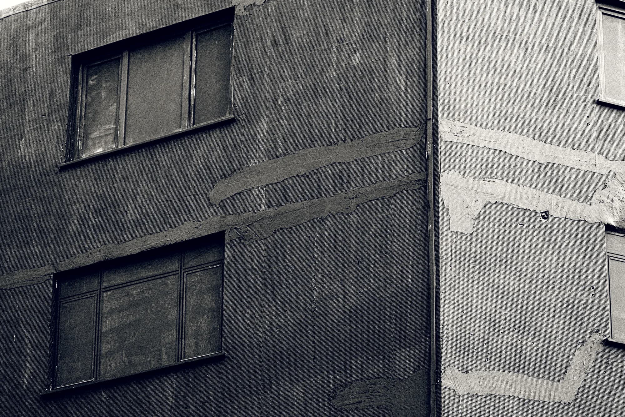 A building facade with a rhythmic grid of windows.
