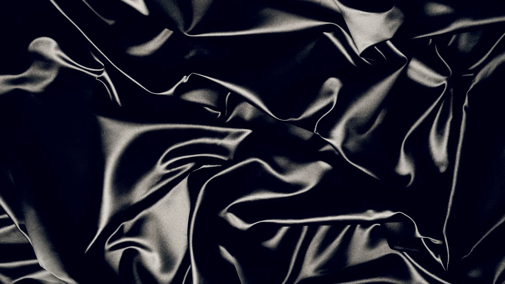 The high-contrast surface of crumpled silk.